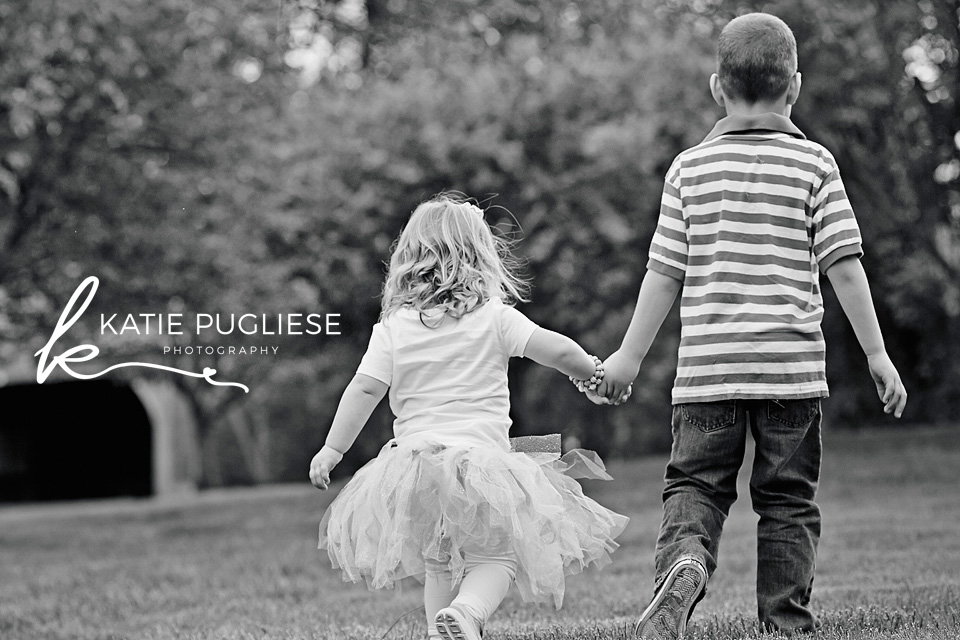 Black and white photo of siblings holding hands