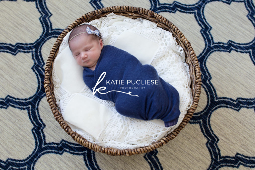 Baby girl blue and white colors sleeping in basket