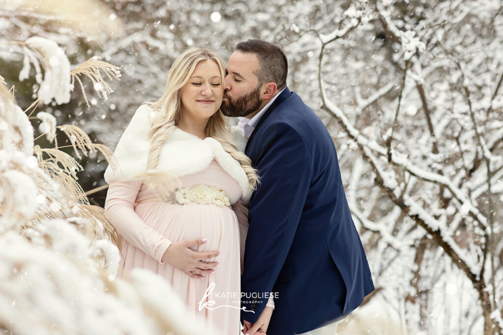 Winter maternity photography session in Connecticut with snow-covered landscape
