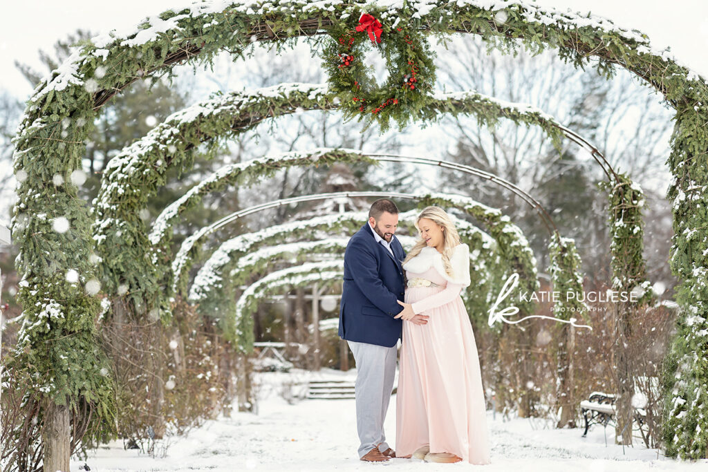 Winter maternity photography session in Connecticut with snow-covered landscape
